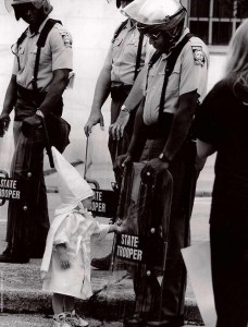 child_of_kkk_touch_black_police_shield